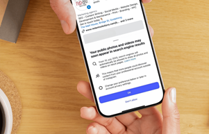 picture of a phone with the update notification about instagram posts for business accounts now displaying on google